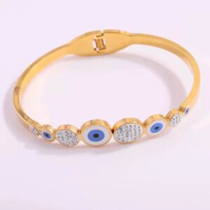 Brazalete con resorte, acero inoxidable, dorado. ojos turcos circulares y con destellos plateados